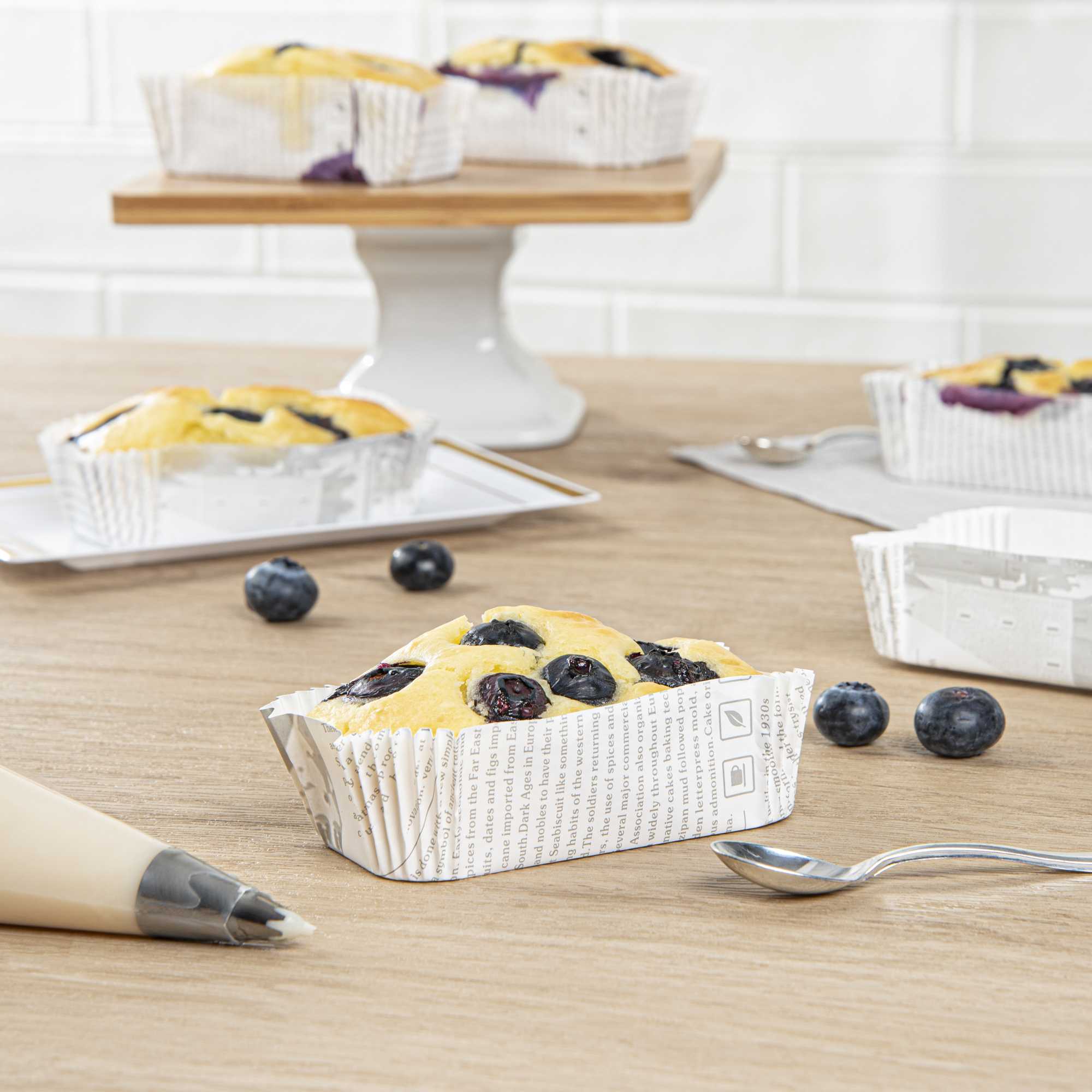 Panificio 5 oz Elliptical Newsprint Paper Large Baking Cup - Ridged - 4 1/2" x 2 1/2" x 1 1/4" - 200 count box