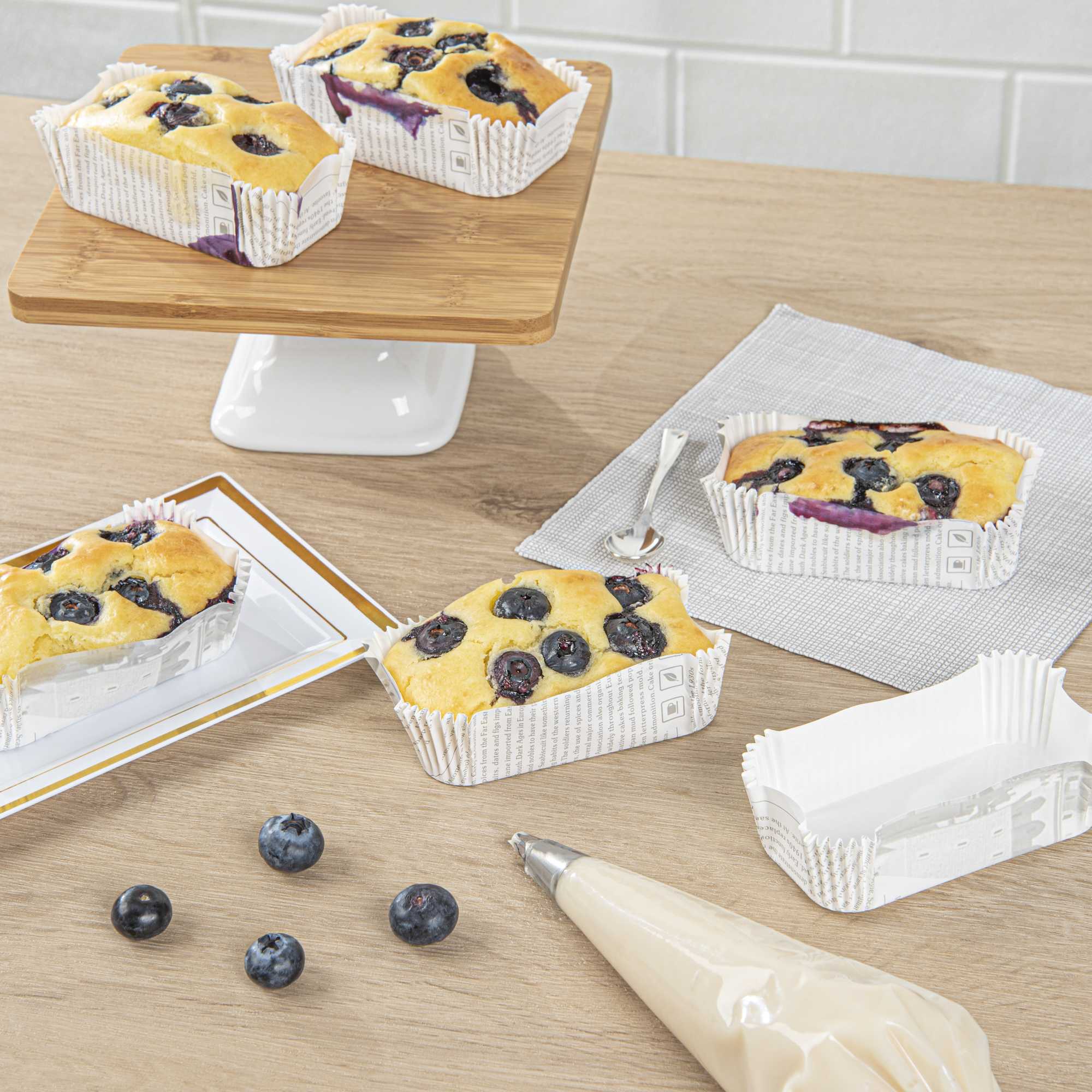 Panificio 5 oz Elliptical Newsprint Paper Large Baking Cup - Ridged - 4 1/2" x 2 1/2" x 1 1/4" - 200 count box
