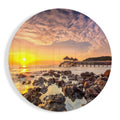Round Golden Pier Sunrise Over Rocks Glass Wall Art